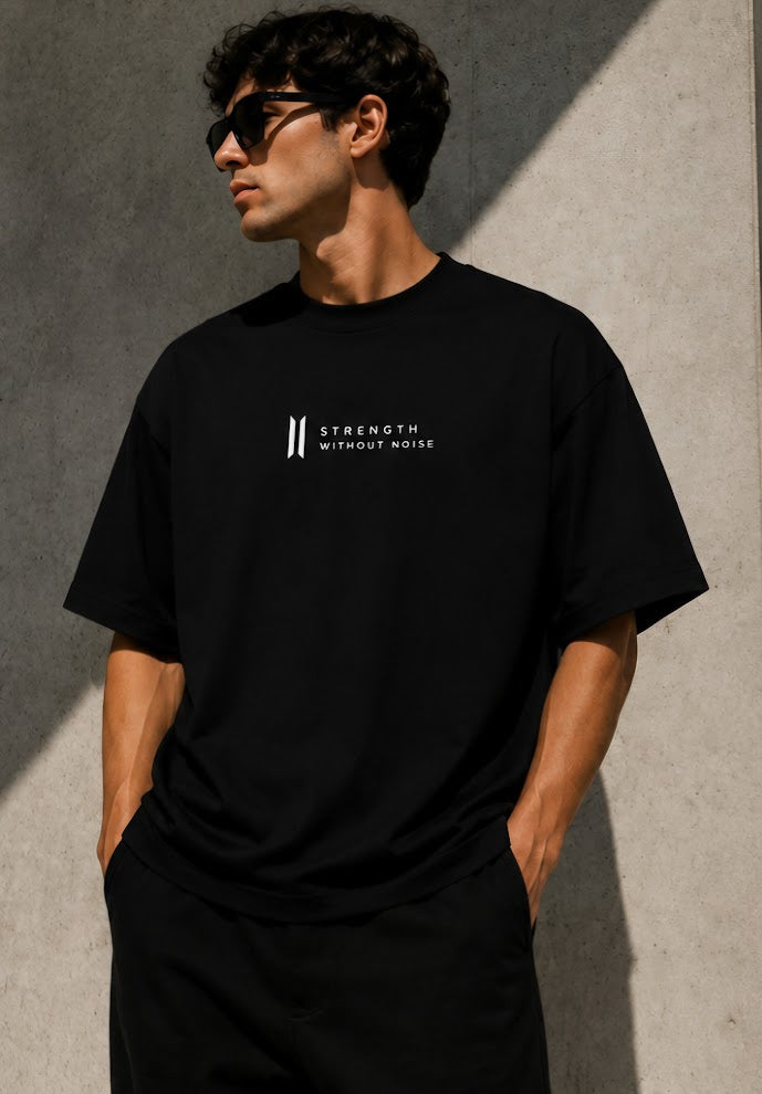 Male model wearing MARLEAU sTRENGTH WITHOUT NOISE OVERSIZED BLACK T-SHIRT